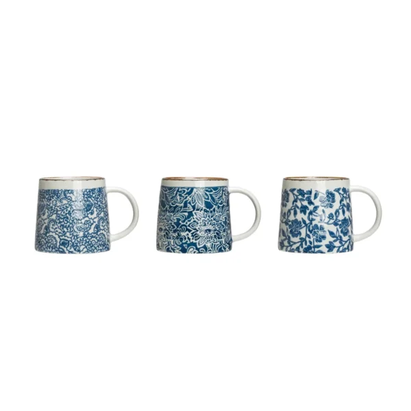 three white and blue 12 oz. mugs with floral designs on white background